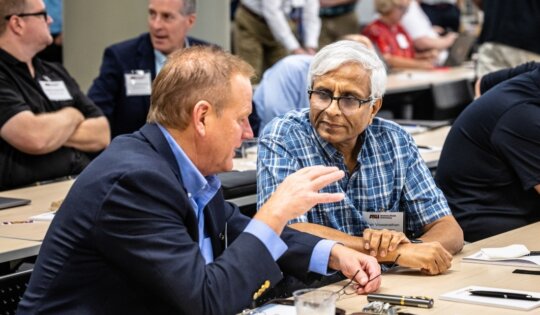 Tim Olson (left), founder and CEO of DECA in Tempe, chats with Vish Viswanathan of NXP Semiconductors during a break at the Southwest Advanced Prototyping Hub workshop for microelectronics. (Photo by Charlie Leight/ASU News)